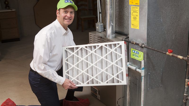 ABC technician holding a clean replacement air filter for better indoor air quality