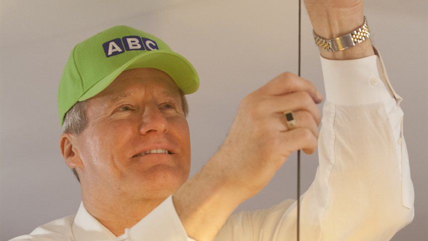 ABC electrician installing a hanging light fixture