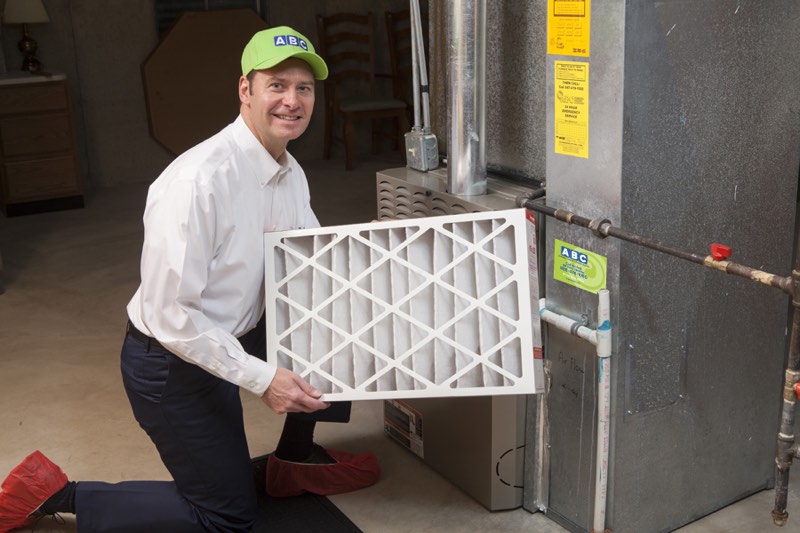 ABC technician holding a clean replacement air filter for better indoor air quality