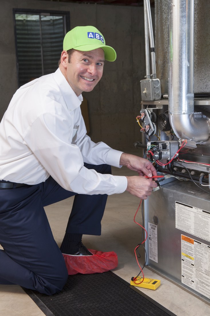 ABC technician testing a furnace control board during a repair