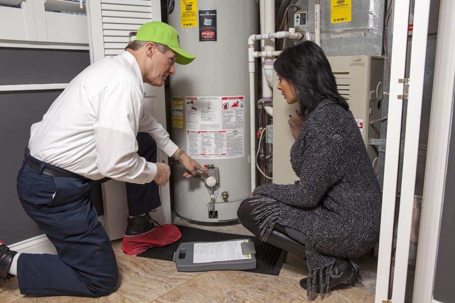 ABC plumber walking a homeowner through a water heater replacement
