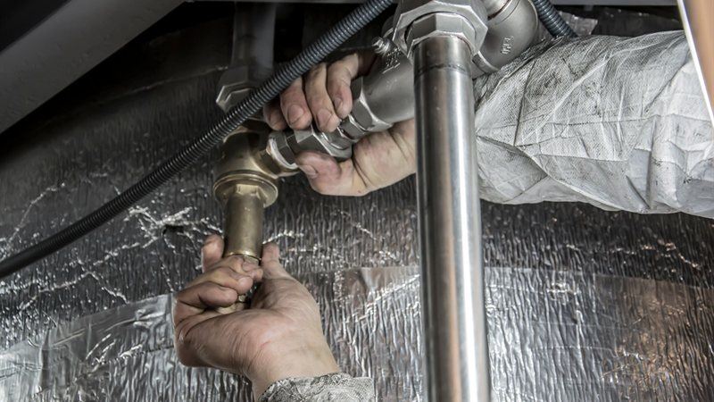 Plumber clearing and servicing a home drain line