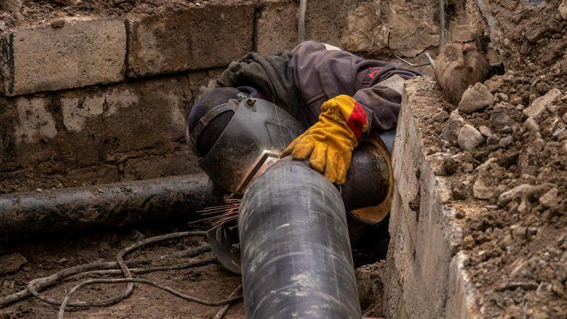 Technician making an urgent sewer line repair on site