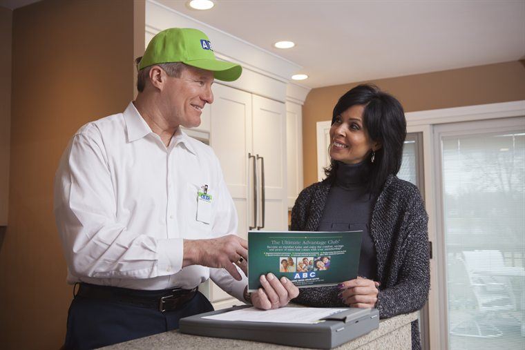 ABC technician helping a Chicagoland homeowner in the kitchen